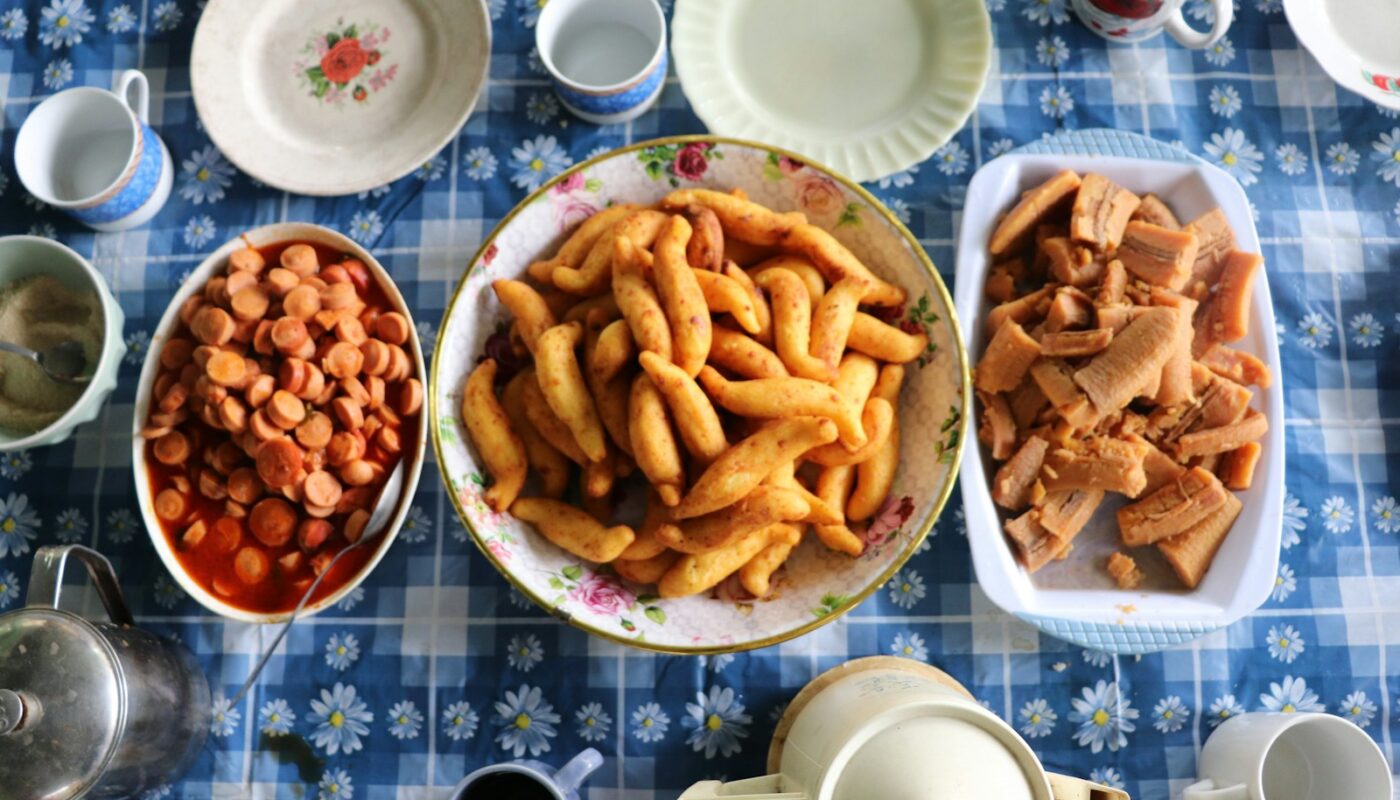 a table topped with bowls of food and cups