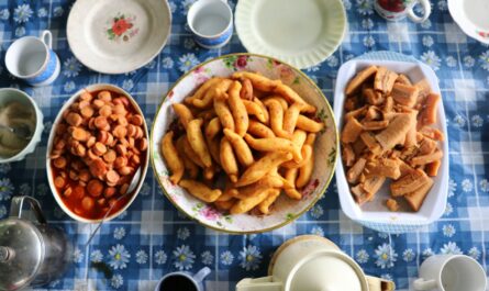 a table topped with bowls of food and cups