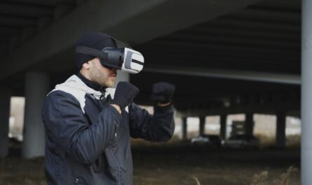 Man wearing vr headset, boxing outdoors under bridge.
