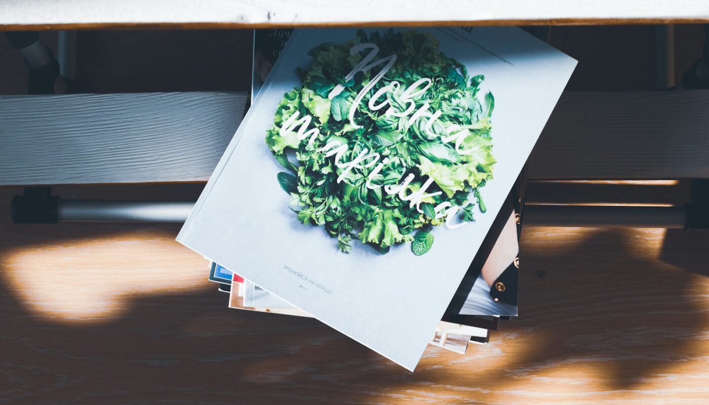 white and green book on gray surface