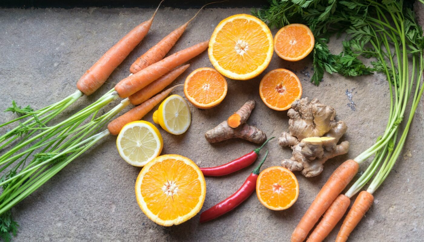 sliced orange fruit beside green and orange vegetable