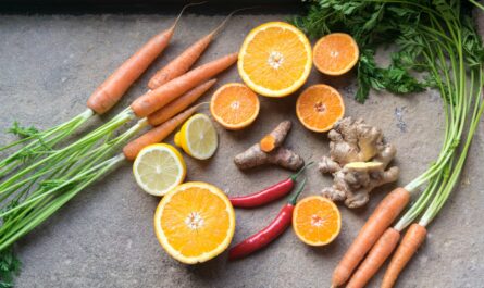 sliced orange fruit beside green and orange vegetable